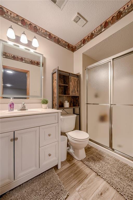full bath with visible vents, a stall shower, and toilet