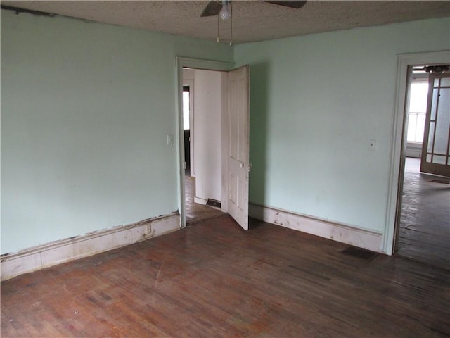 820 Custer St, Trenton, MO 64683 - empty room featuring a ceiling fan, a textured ceiling, visible vents, and wood finished floors