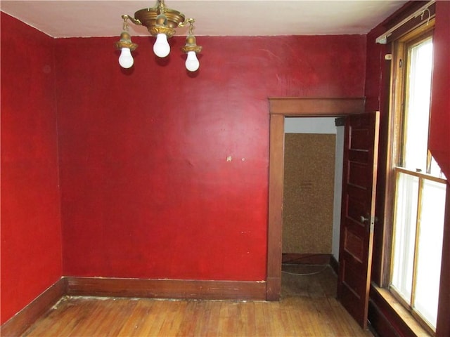820 Custer St, Trenton, MO 64683 - unfurnished room featuring baseboards, wood finished floors, and a healthy amount of sunlight