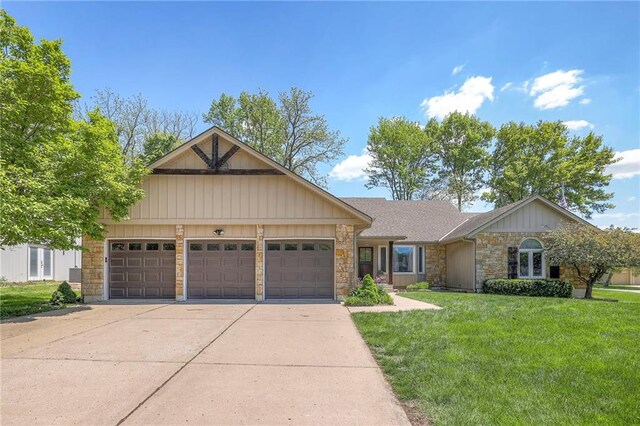 view of front of home with stone siding, a garage, concrete driveway, and a front yard