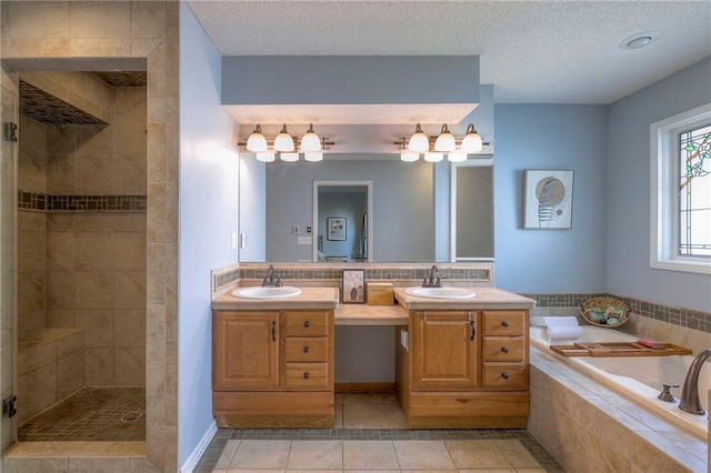 full bathroom with a tile shower, double vanity, a textured ceiling, a bath, and tile patterned flooring