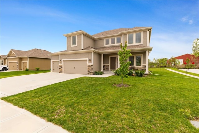 prairie-style house featuring driveway, a garage, a front lawn, stone siding, and stucco siding
