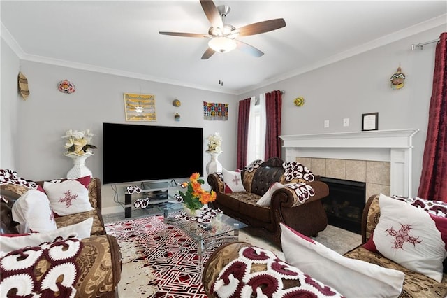 living room featuring a tiled fireplace, ornamental molding, and ceiling fan