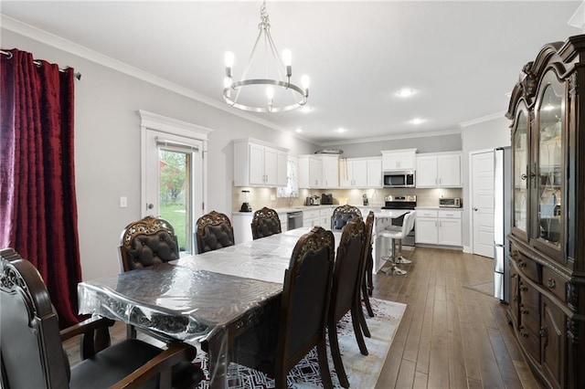dining space featuring recessed lighting, a chandelier, ornamental molding, and dark wood-type flooring