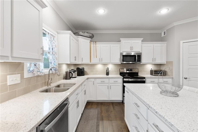 kitchen with white cabinets, stainless steel appliances, visible vents, and a sink