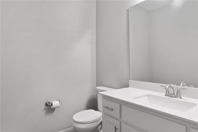 half bathroom featuring toilet and vanity