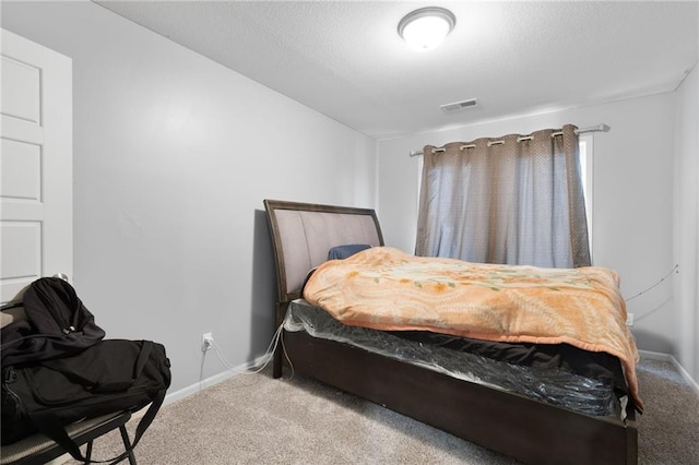 carpeted bedroom featuring visible vents and baseboards