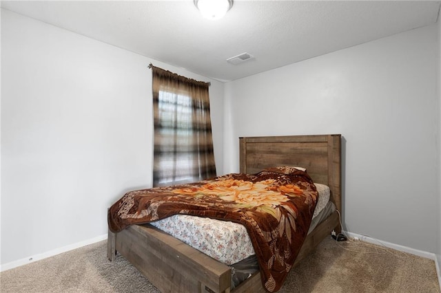 bedroom with visible vents, carpet, and baseboards