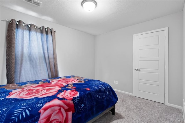 carpeted bedroom featuring visible vents and baseboards