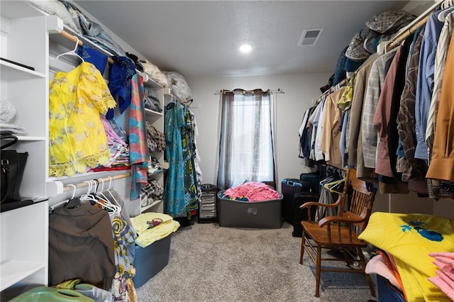 walk in closet featuring visible vents and carpet