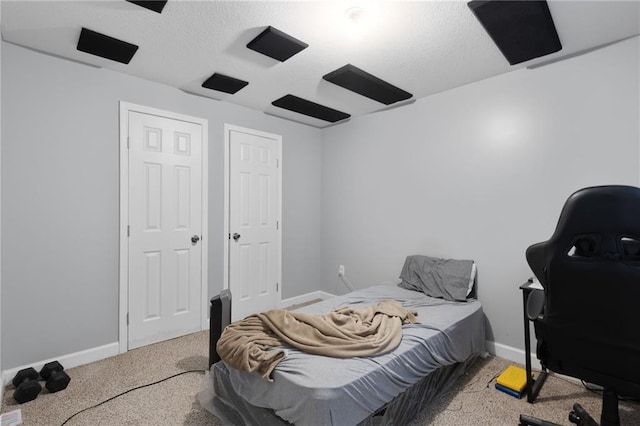 carpeted bedroom with baseboards