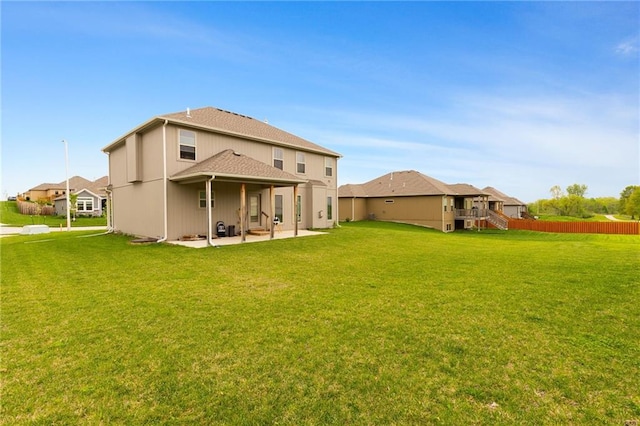 back of house with a lawn, fence, and a patio area