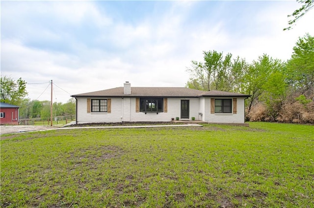1204 E 223rd St, Cleveland, MO 64734 - single story home with a front lawn and a chimney