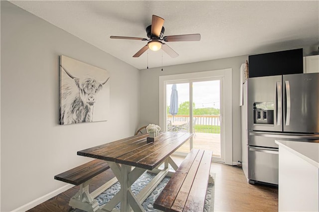 1204 E 223rd St, Cleveland, MO 64734 - dining room with a ceiling fan, baseboards, and light wood-style floors