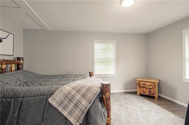 1204 E 223rd St, Cleveland, MO 64734 - bedroom with baseboards and wood finished floors