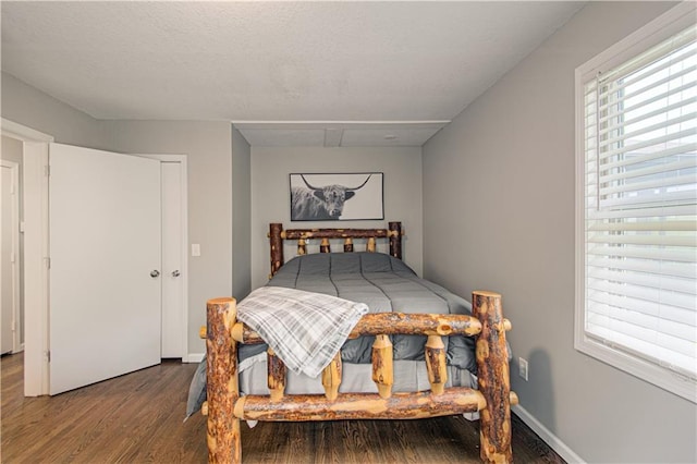 1204 E 223rd St, Cleveland, MO 64734 - bedroom featuring baseboards and wood finished floors
