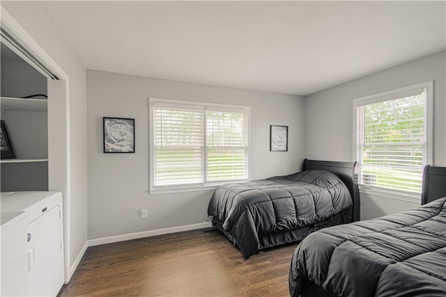 1204 E 223rd St, Cleveland, MO 64734 - bedroom featuring independent washer and dryer, baseboards, and wood finished floors
