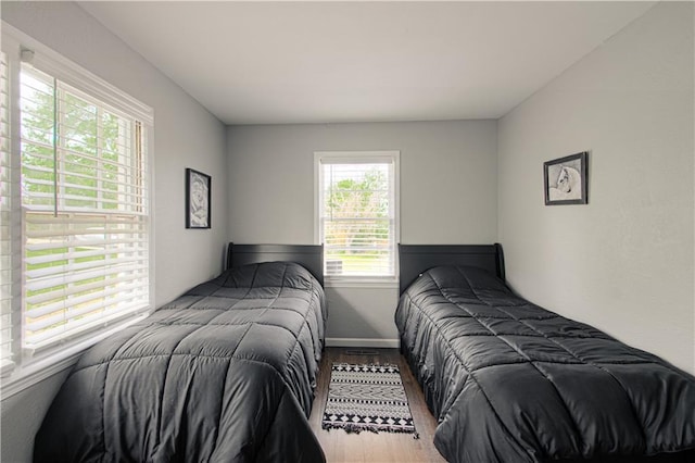 1204 E 223rd St, Cleveland, MO 64734 - bedroom with baseboards and wood finished floors