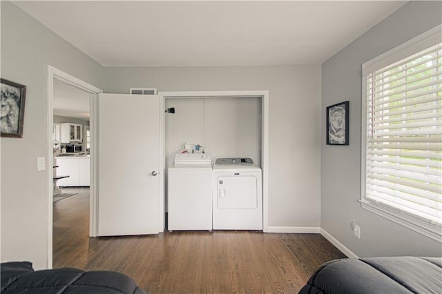 1204 E 223rd St, Cleveland, MO 64734 - clothes washing area with independent washer and dryer, laundry area, baseboards, wood finished floors, and visible vents