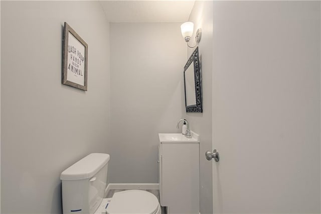1204 E 223rd St, Cleveland, MO 64734 - half bathroom featuring toilet, baseboards, and vanity
