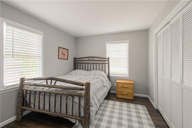 1204 E 223rd St, Cleveland, MO 64734 - bedroom with a closet, baseboards, and wood finished floors