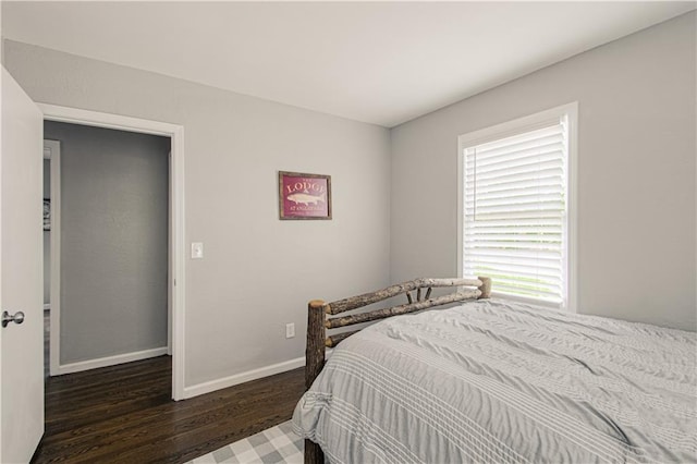1204 E 223rd St, Cleveland, MO 64734 - bedroom featuring baseboards and wood finished floors