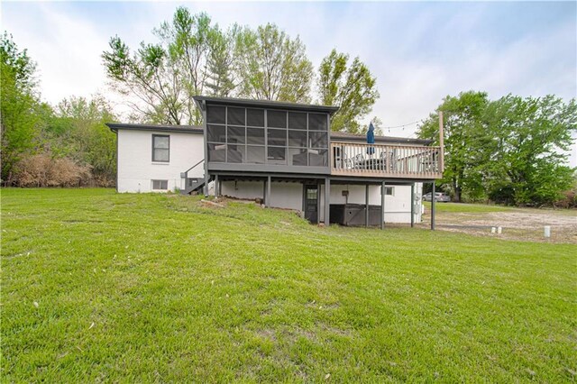 1204 E 223rd St, Cleveland, MO 64734 - back of property with a sunroom, stairs, a wooden deck, and a yard