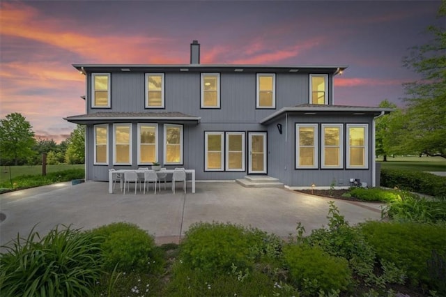 14305 S Gammon Rd, Greenwood, MO 64034 - back of property at dusk featuring a patio area