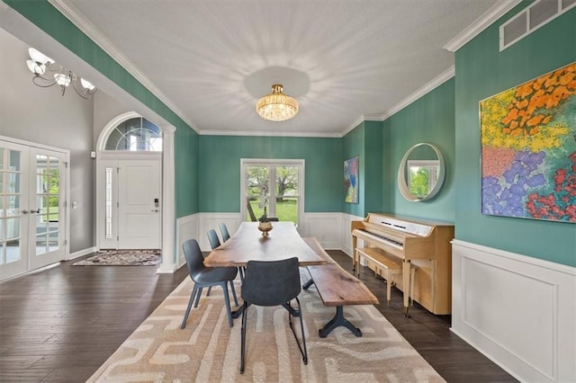 14305 S Gammon Rd, Greenwood, MO 64034 - dining room with french doors, a chandelier, crown molding, a wainscoted wall, and dark wood-type flooring