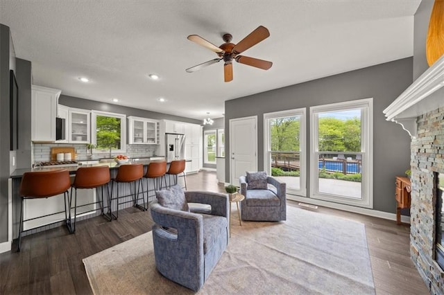 14305 S Gammon Rd, Greenwood, MO 64034 - living area with ceiling fan, dark wood-type flooring, recessed lighting, and a chandelier