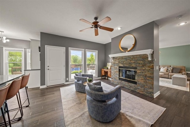 14305 S Gammon Rd, Greenwood, MO 64034 - living area with ceiling fan, healthy amount of natural light, a fireplace, and wood finished floors