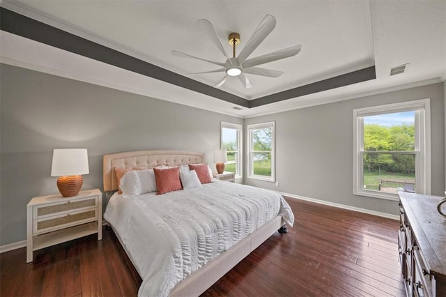 14305 S Gammon Rd, Greenwood, MO 64034 - bedroom with a raised ceiling, ornamental molding, multiple windows, and hardwood / wood-style floors