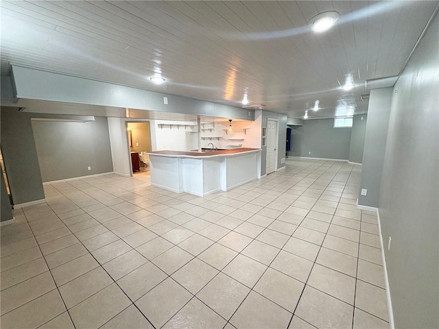 14305 S Gammon Rd, Greenwood, MO 64034 - kitchen featuring open floor plan, light tile patterned flooring, a peninsula, and a kitchen breakfast bar