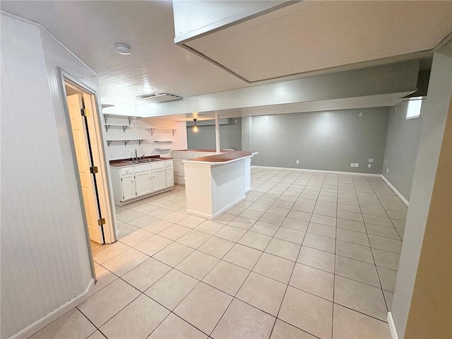 14305 S Gammon Rd, Greenwood, MO 64034 - kitchen with light tile patterned floors, white cabinets, open floor plan, open shelves, and a center island