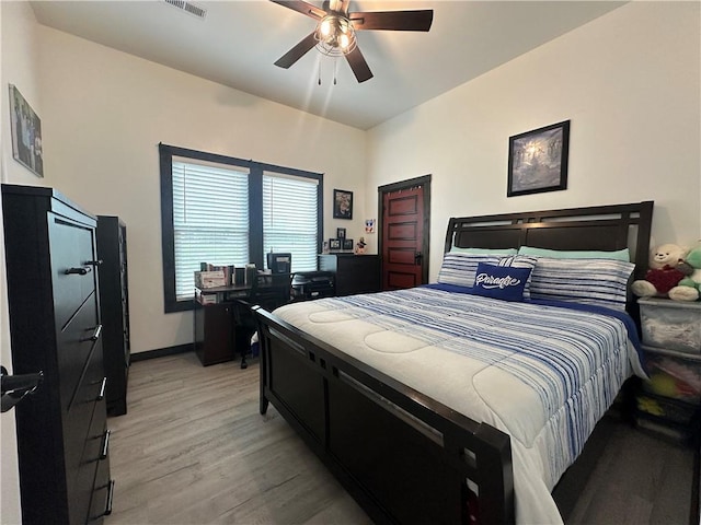 bedroom featuring baseboards, ceiling fan, and light wood-type flooring