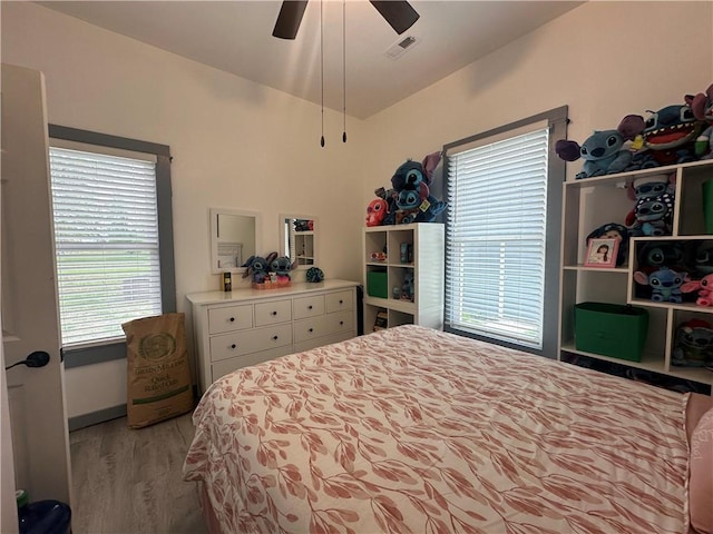 bedroom featuring visible vents, ceiling fan, and wood finished floors