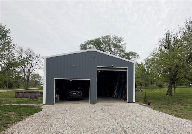 detached garage with gravel driveway
