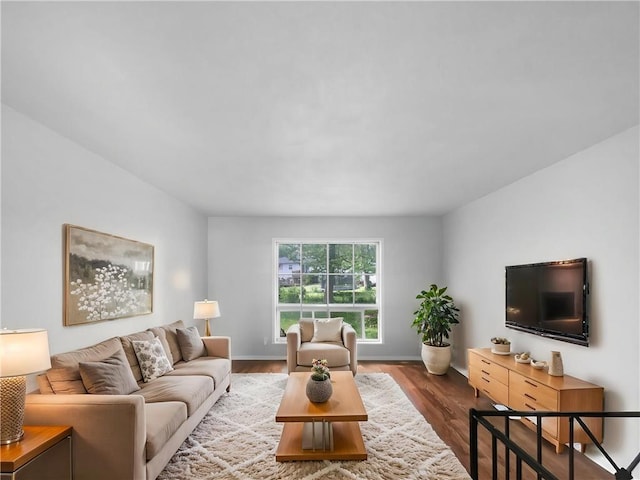 living room with baseboards and wood finished floors