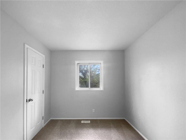 unfurnished bedroom featuring carpet floors and baseboards
