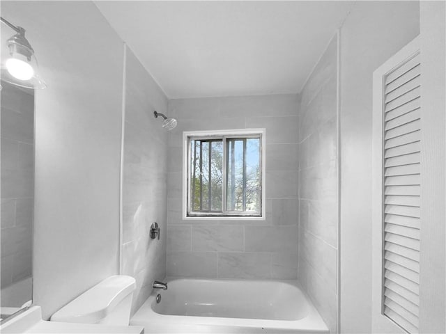 bathroom featuring toilet and bathing tub / shower combination