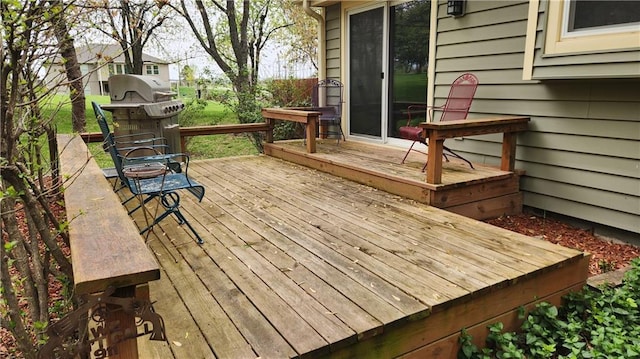 wooden terrace featuring a grill