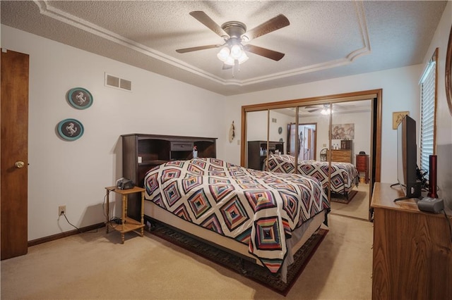 carpeted bedroom featuring visible vents, a ceiling fan, a textured ceiling, and baseboards