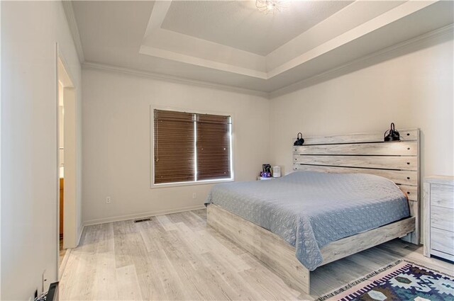 4515 67th Ter, Kansas City, MO 64119 - bedroom featuring a tray ceiling, wood finished floors, baseboards, and ornamental molding
