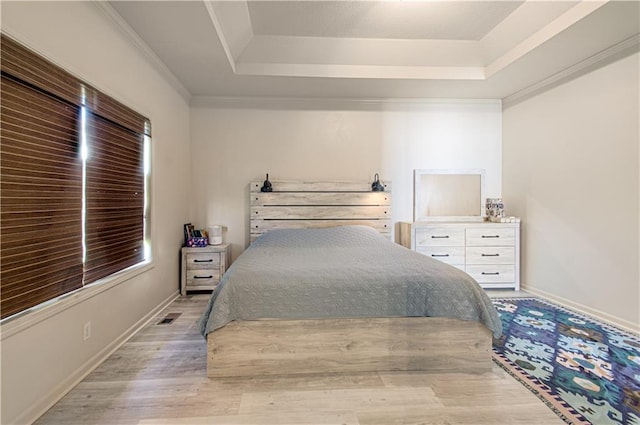 4515 67th Ter, Kansas City, MO 64119 - bedroom with a tray ceiling, wood finished floors, multiple windows, and baseboards