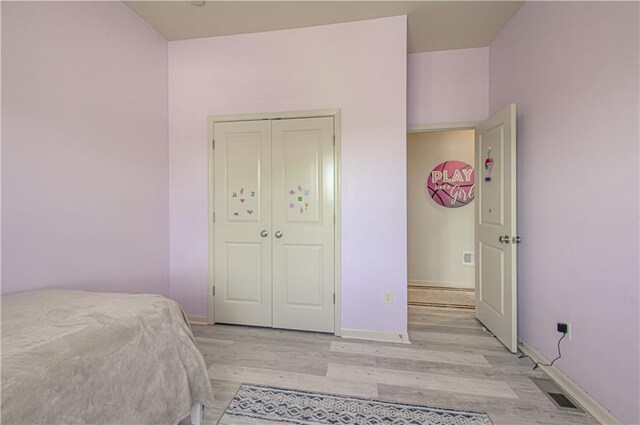 4515 67th Ter, Kansas City, MO 64119 - bedroom with light wood-style floors, baseboards, and a closet
