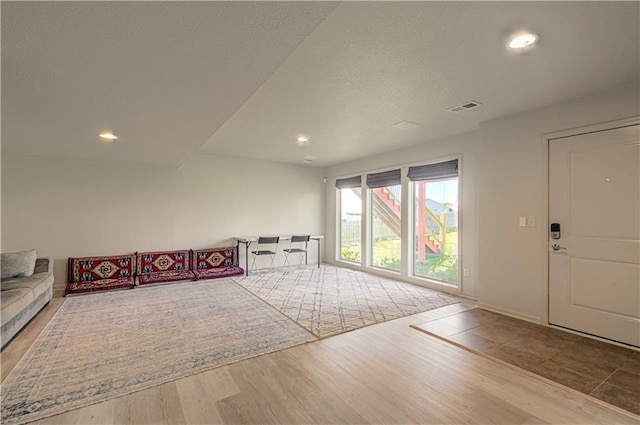 4515 67th Ter, Kansas City, MO 64119 - unfurnished living room with wood finished floors, recessed lighting, and baseboards
