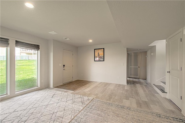 4515 67th Ter, Kansas City, MO 64119 - foyer featuring a textured ceiling, light wood finished floors, recessed lighting, and baseboards