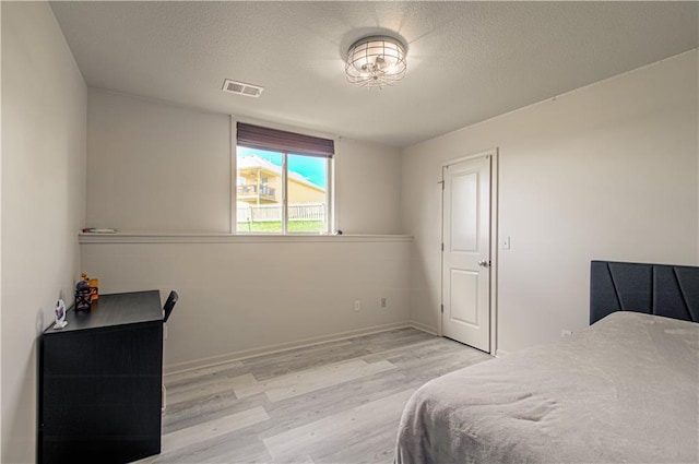 4515 67th Ter, Kansas City, MO 64119 - bedroom with light wood-type flooring, a textured ceiling, and baseboards
