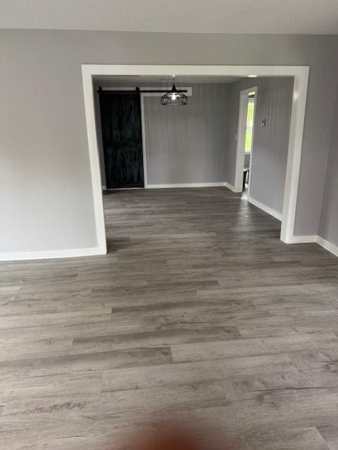 403 W Cedar St, Waverly, MO 64096 - spare room featuring baseboards and wood finished floors