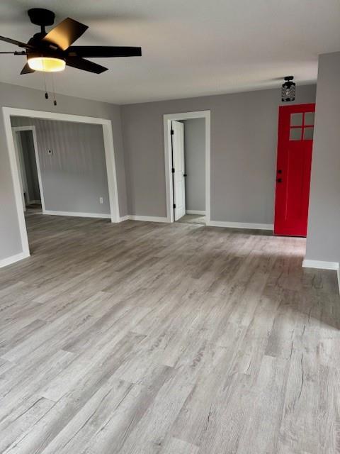 403 W Cedar St, Waverly, MO 64096 - spare room featuring a ceiling fan, wood finished floors, and baseboards